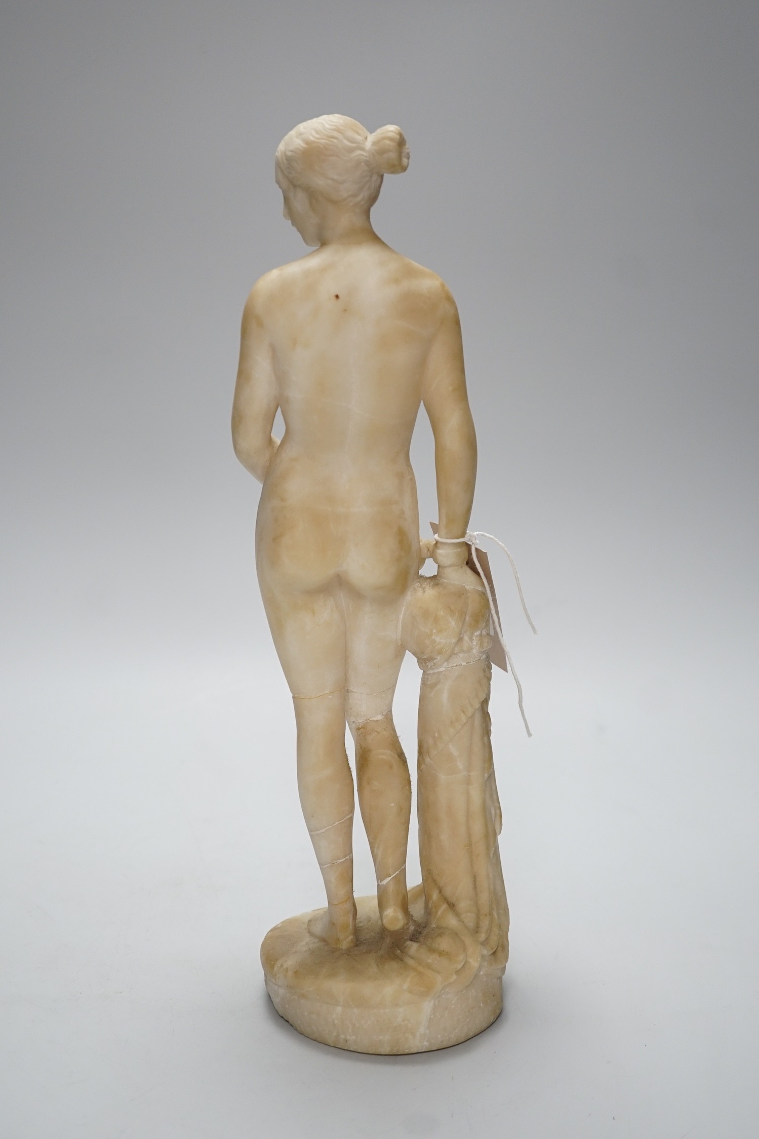A carved alabaster female classical figure, the Greek slave Hiram Powers, 36cms high
